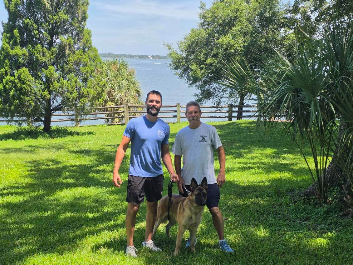 Mold detection dog Ember with owner Ryan Rainey and her trainer Bill Whitstine